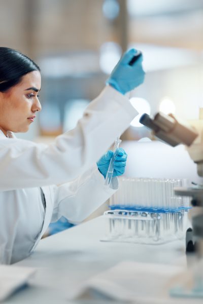 Science, laboratory and woman with pipette, test tube and biotech solution in research. Medical innovation, scientist or lab technician in study for healthcare, medicine and vaccine results feedback.